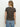 A woman with long, light brown hair faces away, wearing Sanctuary Clothing's "the perfect tee french kitty" and light blue jeans against a plain white background.