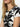 A woman with long blonde hair wears the perfect tee inked impressions by Sanctuary Clothing. She accessorizes with gold hoop earrings and a gold pendant necklace, and the image captures her from neck to chest, partially obscuring her face.