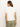A woman with long brown hair draping over her shoulders is seen from behind, wearing the embroidered perfect tee in white by Sanctuary Clothing paired with olive green pants and hoop earrings, set against a plain white background.