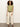 A woman with curly hair wears Sanctuary Clothing's knotted muscle tee bamboo in light green, tucked into high-waisted wide-leg cream pants with a brown belt and brown sandals, standing against a plain light background.