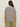 A person with long brown hair wears Sanctuary Clothing's notch neck tee in light oat black stripe, paired with olive green pants, standing against a plain light background.