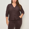 A woman with long brown hair wears the Sanctuary Clothing textured knit Dreamgirl Top in Semi Sweet (extended sizing) with matching brown pants, standing against a plain light-colored background.