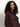 A woman with long, curly dark hair wears the Sanctuary Clothing fitted mesh button down top boheme in maroon, looking slightly to the side against a plain light background.