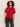 A woman with curly hair wears the Sanctuary Clothing satin mix tee in cherry lacquer, featuring short sleeves and a gathered knot detail, paired with dark jeans against a plain light background.