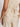 A person models the Sanctuary Clothing œrelaxed modern vest sand sequin stripe� top�light beige, textured, sleeveless, with a fabric waist tie�paired with matching pants. The image shows the back and side view from shoulder to thigh.