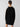 A person with their hair tied back is seen from behind wearing the Sanctuary Clothing Speedway Sweater Dress in Black Milk Toasted Almond, accessorized with hoop earrings and a chain necklace. They are standing against a plain light gray background.