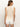 A person with long hair is wearing the open stitch shell sweater eco natural by Sanctuary Clothing with white shorts, standing against a plain background. They are facing away, highlighting the sweater's detailed pattern.