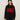 A woman with long brown hair models the Sanctuary Clothing "apres intarsia high mock logo sweater" in black/mars red, featuring bold red "APRÈS" lettering, paired with a black knit pom-pom hat and black pants against a light background.