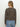 A woman with long, straight blonde hair is seen from the back wearing Sanctuary Clothing’s must have cardi french kitty sweater in brown and black leopard print, paired with light blue jeans against a plain white background.