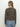 A woman with long, straight blonde hair is seen from the back wearing Sanctuary Clothingžs must have cardi french kitty sweater in brown and black leopard print, paired with light blue jeans against a plain white background.