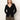 A woman with straight, light brown hair models the Sanctuary Clothing fitted raglan cardi in black, paired with olive green pants, against a plain light background.