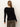 A person with long, straight light brown hair stands with their back to the camera, wearing the Sanctuary Clothing fitted raglan cardi in black and olive-green pants against a plain light background.