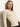 A woman with straight, light brown hair models the Sanctuary Clothing fitted raglan cardi in light oat—cream-colored, textured knit with a V-neck and button-up front—against an off-white background.