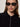 A woman with long brown hair wears black oval sunglasses, large silver hoop earrings, and the Sanctuary Clothing button down variegated cardi in black, confidently looking at the camera against a neutral background.