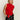 A woman with straight blonde hair models Sanctuary Clothing's cherry lacquer scarf sweater shell, a sleeveless red top with a long scarf detail, paired with a shiny black leather skirt against a plain background.