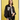 A woman with shoulder-length brown hair stands against a yellow background, wearing the Sanctuary Clothing right on jacket black over a white t-shirt and black pants, her expression neutral.