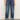 Wearing Sanctuary Clothing’s soleil 90s straight jeans in indigo medium with rolled cuffs and brown suede ankle boots, the person stands on a neutral floor against a plain off-white wall.