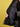 Against a yellow background, someone in black jeans and a black tank top holds open the Sanctuary Clothing x PEANUTS 75th Anniversary 75 varsity jacket (black white), revealing its patterned lining.