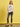 Woman wearing a beige sweatshirt with a graphic design on a yellow background