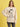 Person wearing a beige sweatshirt with a graphic of Snoopy and 'Joe Cool' text on a yellow background