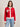 A woman with straight brown hair wears the Sanctuary Clothing x PEANUTS 75th Anniversary "joe cool zip up sweater cherry lacquer"—a red zip-up with white trim and "RIGHT ON" on the left chest—paired with light blue jeans against a plain light background.