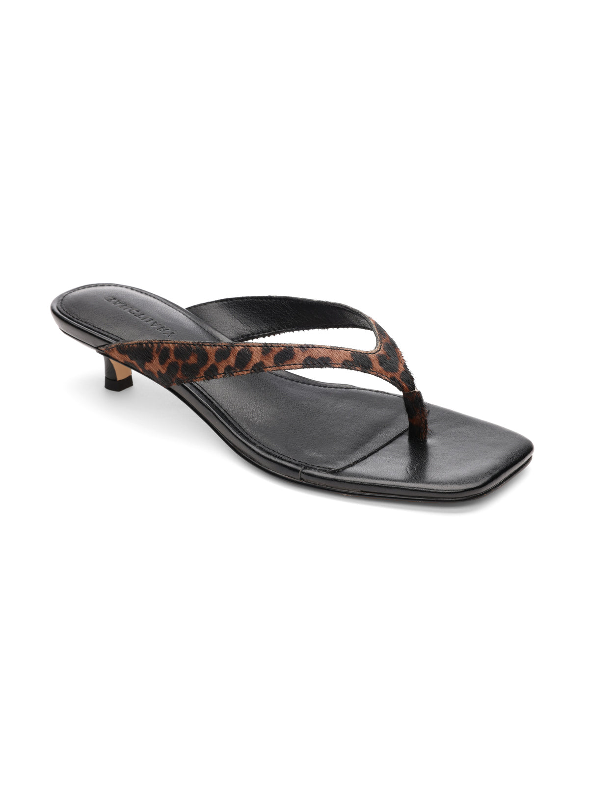 The ease sandal by Sanctuary Clothing is black with a square toe and thin, low heel. It features a thong strap with a leopard print design for a stylish and modern look.
