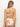 A woman with long hair faces away, wearing Sanctuary Clothing's charming floral v wire bandeau in white. The strapless bikini features a back tie and large pink and green flowers. She wears minimal accessories, including small hoop earrings, against a neutral background.