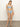 A woman models the Sanctuary Clothing refresh rib high leg high rise blue chateau bikini, standing barefoot on a plain floor. Her head tilts slightly, one arm relaxed at her side against a neutral off-white wall.