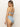 A person with long hair wears the "Refresh Rib High Leg High Rise Blue Chateau" strapless bikini by Sanctuary Clothing. It features a ribbed texture, tied bow back, and the person is looking over their shoulder against a plain background.