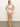 A person with long blonde hair stands barefoot on a gray floor, posing in a ribbed texture Sanctuary Clothing "Refresh Rib High Leg High Rise White" two-piece swimsuit, against a neutral background with hands on hips.