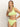 A woman with straight blonde hair models the Sanctuary Clothing stay connected one shoulder bikini top in daiquiri, featuring a knot detail on the strap, against a plain light background.
