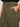 Close-up of a person wearing Sanctuary Clothing's boyfriend utility pant in kalamata, extended sizing, with one hand in a front pocket. They pair it with a black top and have neatly manicured nails with light polish.