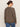 A person faces away from the camera against a plain light background, wearing sunglasses, blue jeans, and the Sanctuary Clothing 24 7 Popover French Kitty top in extended sizing.
