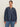 A woman wears the Sanctuary Clothing personal best blouse moonshadow (extended sizing), a loose-fitting, long-sleeve dark denim top with a round neck and buttoned front, paired with blue jeans against a plain light background.
