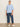 A woman stands against a plain light background wearing the Sanctuary Clothing perfect sweater tee in blue powder (extended sizing), styled with loose-fitting blue jeans and white sneakers. She looks forward, relaxed, with her hands at her sides.