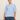 A woman stands against a beige background wearing the Sanctuary Clothing perfect sweater tee in blue powder (extended sizing) with blue jeans, her hair pulled back as she looks confidently at the camera.
