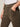 Close-up of a person wearing Sanctuary Clothing’s corduroy hayden bootcut pant in kalamata, styled with a white tucked-in shirt and one hand in the pocket.