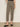Someone wearing Sanctuary Clothing's cadence 90 straight crop jeans in the French Kitty leopard print, styled with black flats, stands against a plain light-colored wall.
