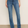Someone wearing Sanctuary Clothing's Sculpted Hayden Bootcut Lucky Streak jeans stands against a light wall, pairing the high-waisted denim with beige pointed-toe shoes.