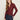 A woman with long, light brown hair wears the Sanctuary Clothing dreamgirl lace button up night berry shirt and dark blue jeans, standing against a plain light background and looking at the camera with a neutral expression.