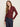 A woman with long, light brown hair wears the Sanctuary Clothing dreamgirl lace button up night berry shirt and dark blue jeans, standing against a plain light background and looking at the camera with a neutral expression.