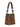 The perfect bucket bag leopard by Sanctuary Clothing features a bold leopard print and a wide matching strap with silver ring accents. The bag stands upright against a white background.