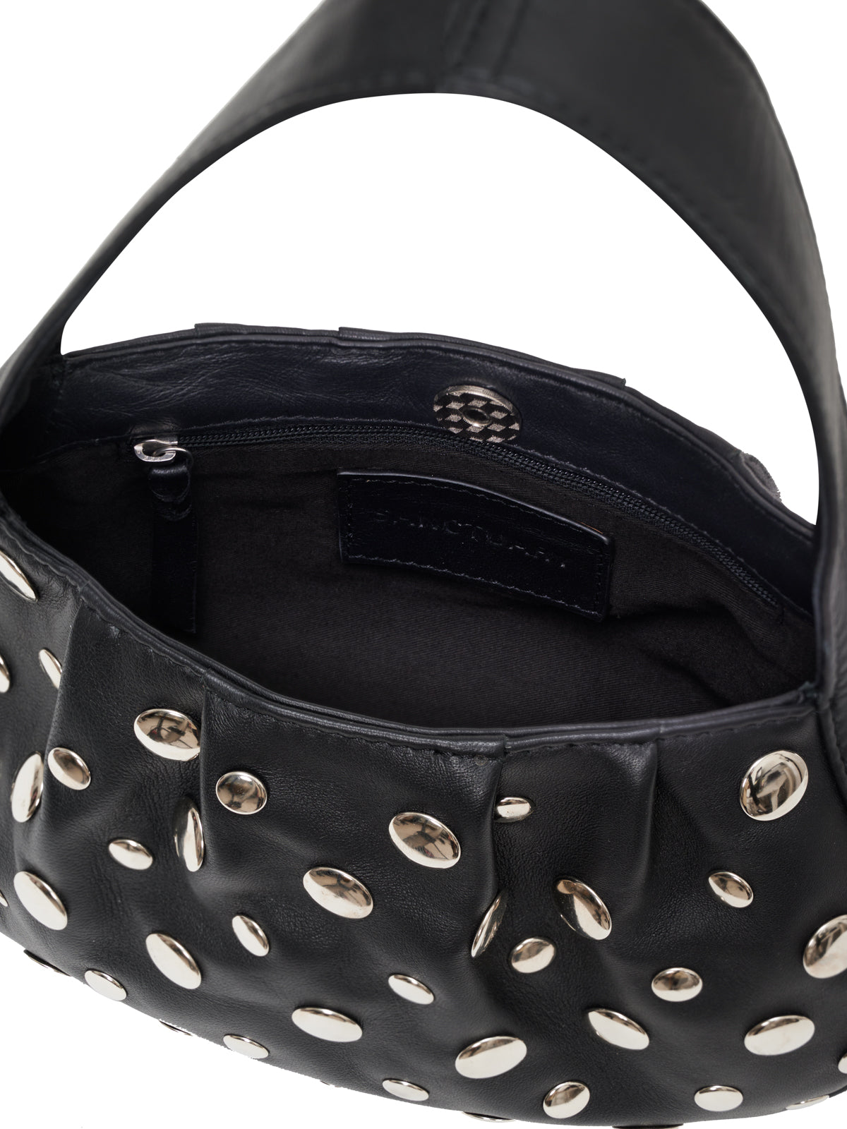 A close-up of the Sanctuary Clothing "charm bag black" shows silver oval studs, a black zipper pocket, and a black brand label inside. The partially open bag reveals its lining and interior details.