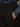 A person wearing Sanctuary Clothing's ponte barrel trouser in black and a blue denim shirt has their right hand in their pants pocket.