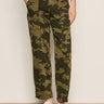 A person models the Sanctuary Clothing boyfriend utility pant in rambler camo, featuring side pockets and a relaxed fit, paired with white sneakers and a beige top. Only the lower half is visible against a plain background.