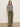 A woman with straight brown hair and a neutral expression stands against a light wall, wearing the Sanctuary Clothing boatneck long sleeve tee in light oat black stripe 3, olive cargo pants, and leopard print flats.
