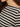 Close-up of a person wearing the Sanctuary Clothing boatneck long sleeve tee in light oat black stripe, showing part of their neck, chin, and dark brown hair.