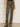 Wearing Sanctuary Clothing's Sculpted Brook Bootcut Pant in Kalamata, paired with leopard print flats, a person stands against a plain light wall—only their lower half is visible.