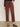 A person, visible from the waist down, stands against a light wall wearing Sanctuary Clothing's cadence 90s straight crop jeans in chicory and leopard print Mary Jane shoes.