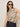 A woman with straight brown hair models the Sanctuary Clothing fuzzy leopard shell mother leo top and high-waisted dark jeans, wearing dark sunglasses and posing with one hand on her hip against a neutral background.